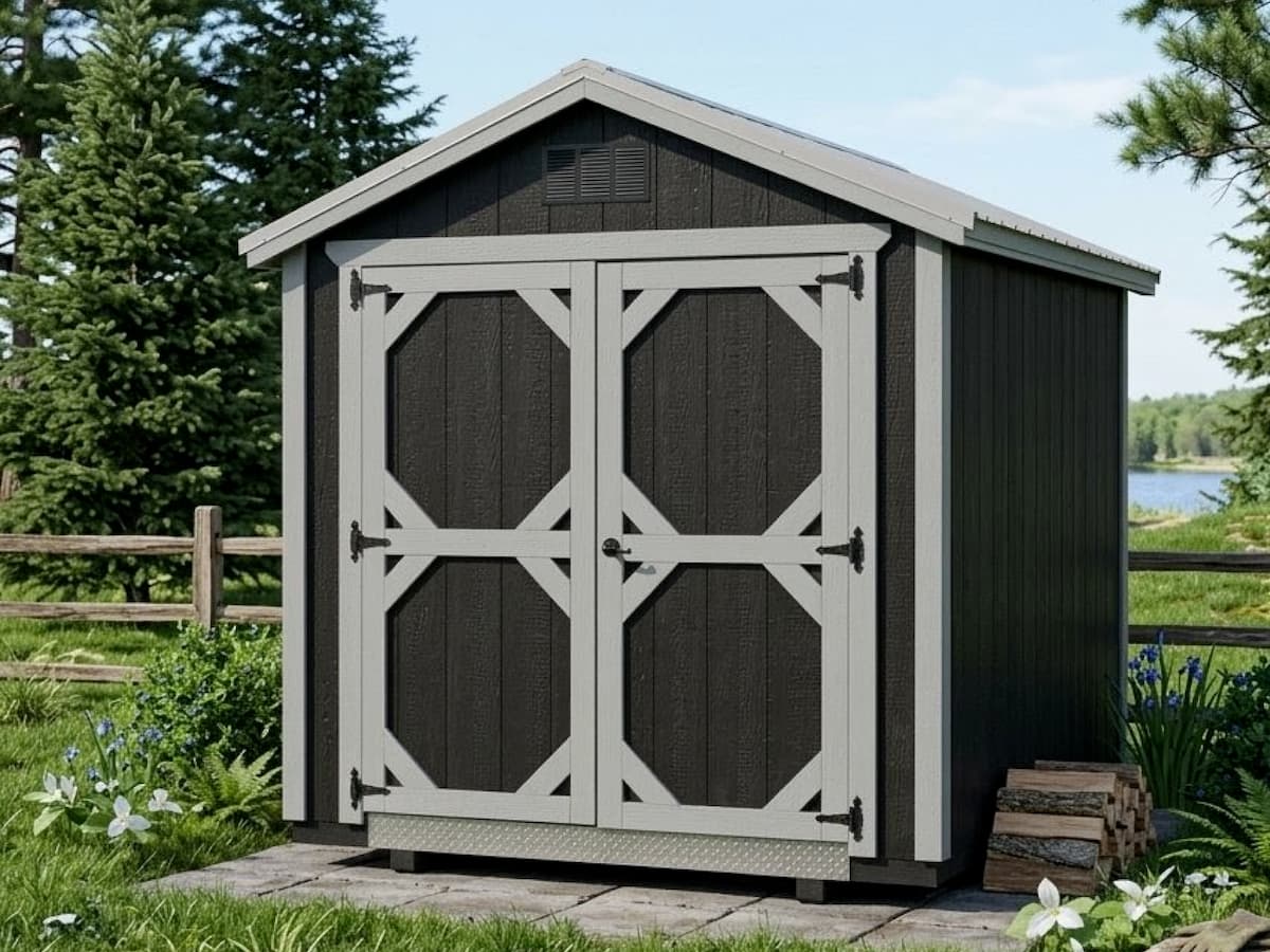 Dark gray Gable Shed with light trim double barn doors beside a lake